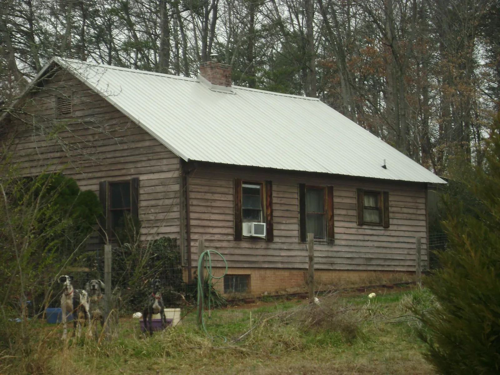 White metal roof on an old wood sided farmhouse, from a Metal Roof Installation job in Athens